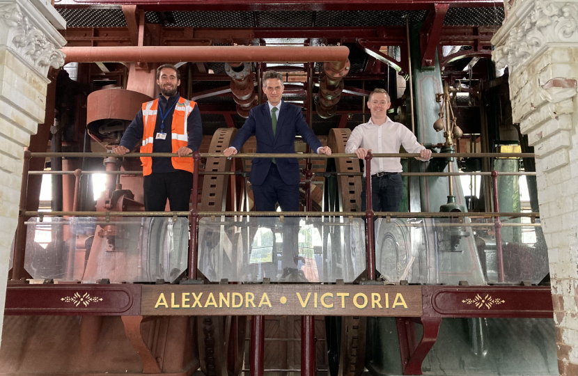 Sir Gavin Williamson with councillor Dan Kinsey and Project Manager James stand in front of part of the pumping station
