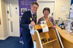 Sir Gavin Williamson is joined by a volunteer at the Marie Curie coffee morning
