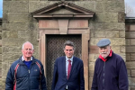 Sir Gavin is joined by Councillor Philip Leason and a volunteer, they stand infront of the Jervis family mausoleum