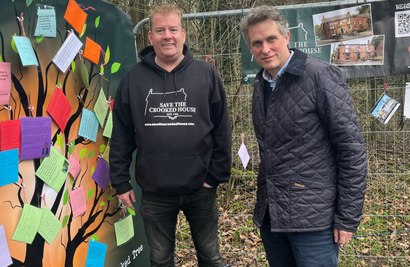 Sir Gavin Williamson is joined by Crooked House campaigner Paul Turner next to the memorial wall