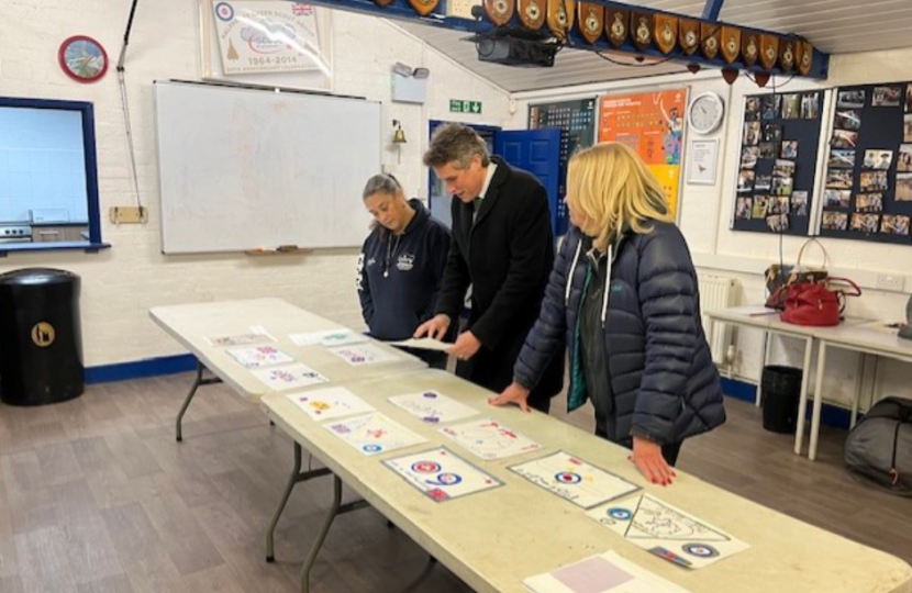 Sir Gavin Williamson helping to judge badges made by the scouts for the badge design competition