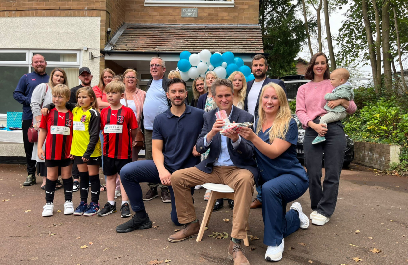 Sir Gavin Williamson is joined by Naomi and Johnathan Price among a group of supporters as they sit outside the new Codsall Health Care Centre