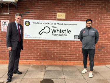 Sir Gavin Williamson stands with Ajay Sharma, co-founder and managing director of The Whistle Foundation