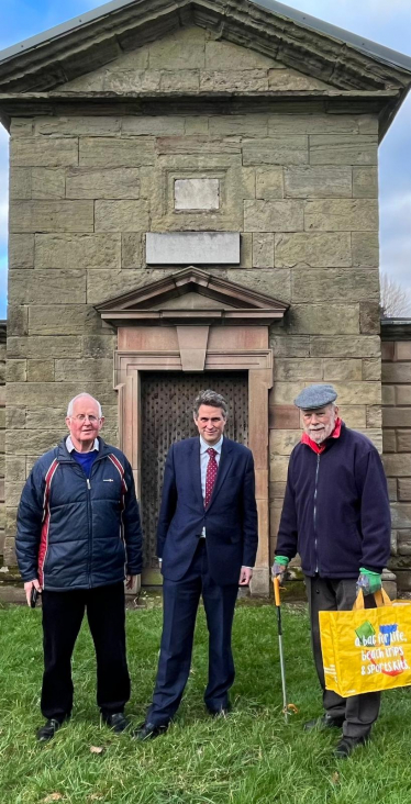 Sir Gavin is joined by Councillor Philip Leason and a volunteer, they stand infront of the Jervis family mausoleum
